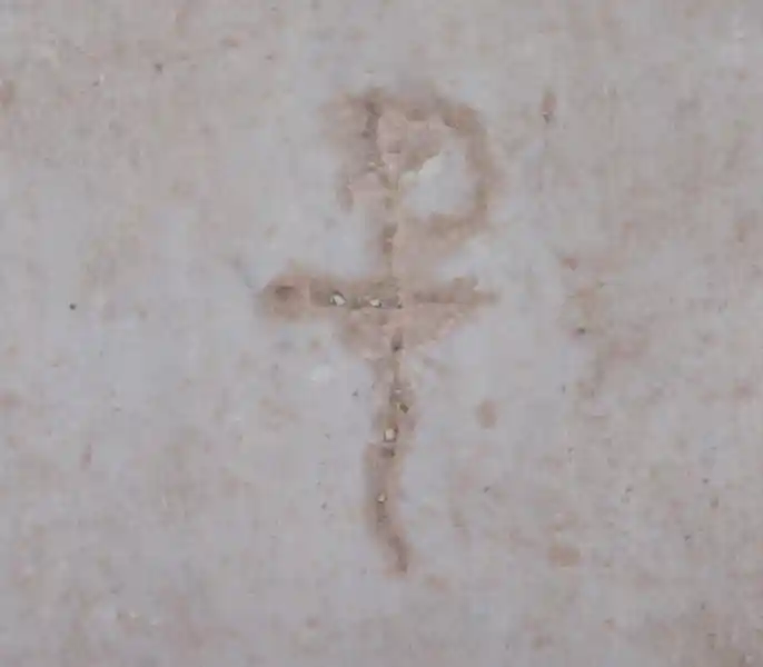 Chi-rho symbol on a marble. Cross with a wiggly tail engraved on marble in the ruins in Curetes Street, Ephesus Izmir